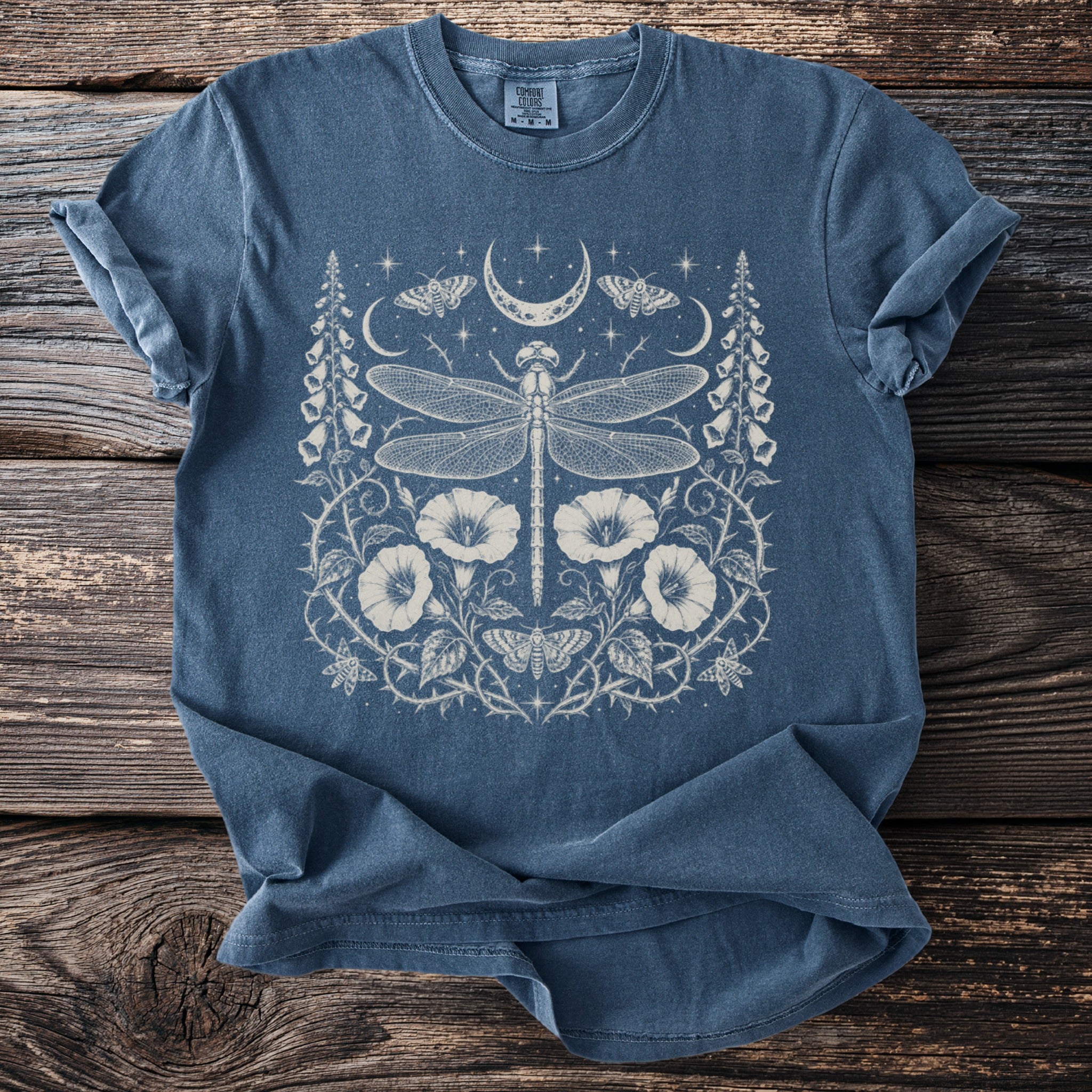 Blue t-shirt with cream lunar dragonfly and floral graphic print.