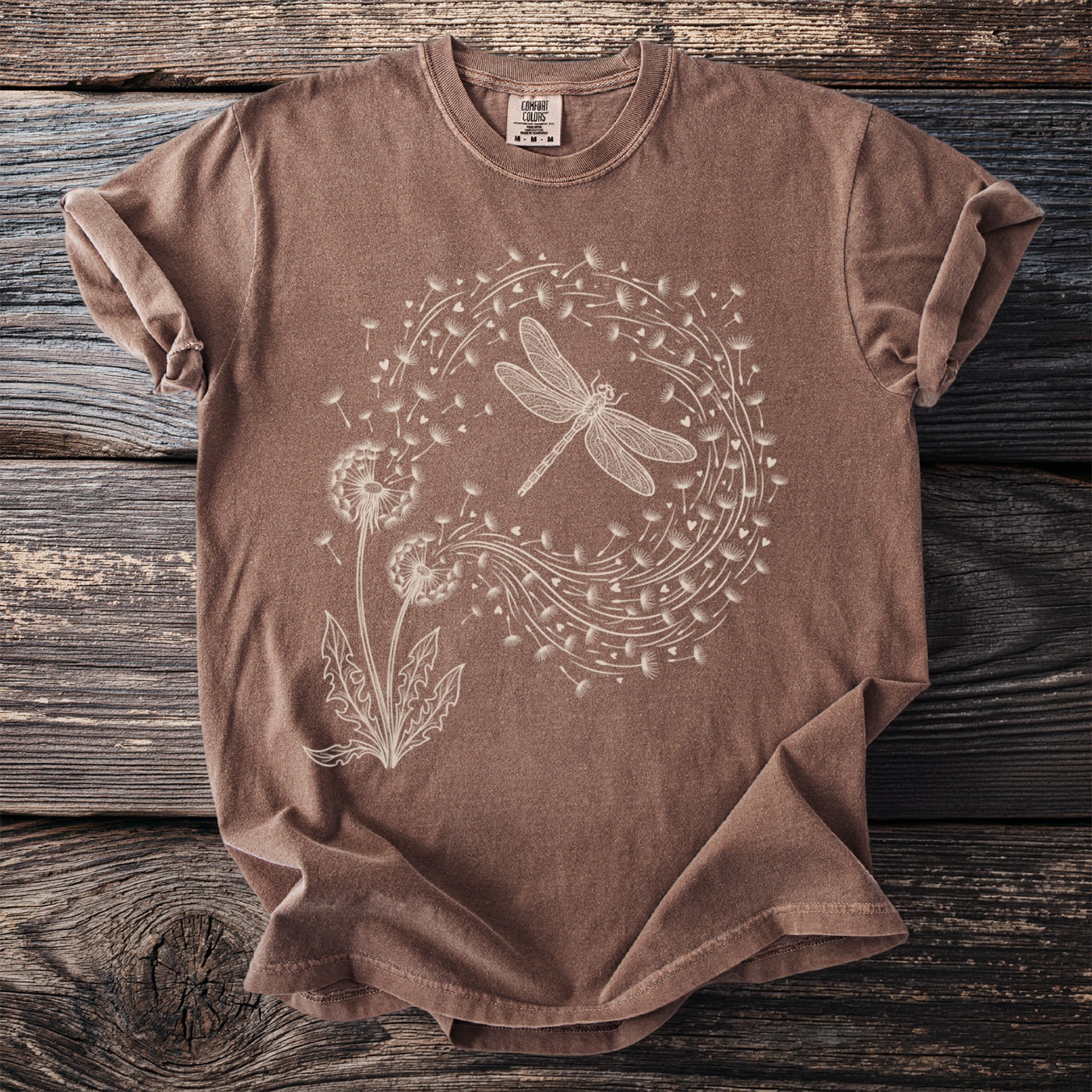 Brown t-shirt with a white line art dragonfly and dandelion design.
