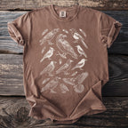 Brown t-shirt with a vintage-style sketch of various birds and feathers.