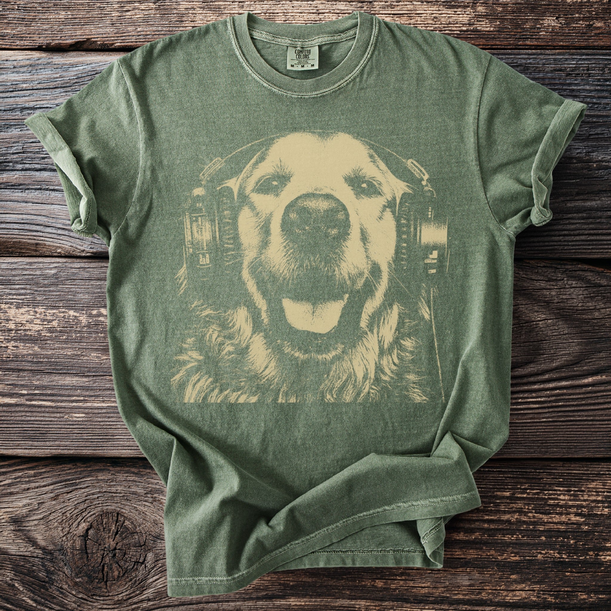 Green t-shirt with a cream-colored graphic of a happy dog wearing headphones.
