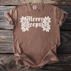 Brown t-shirt with "Merry Creepmas" and poinsettia graphics.