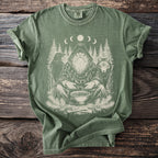 Green t-shirt with a print of a bearded figure, raven, wolf, and moon phases.