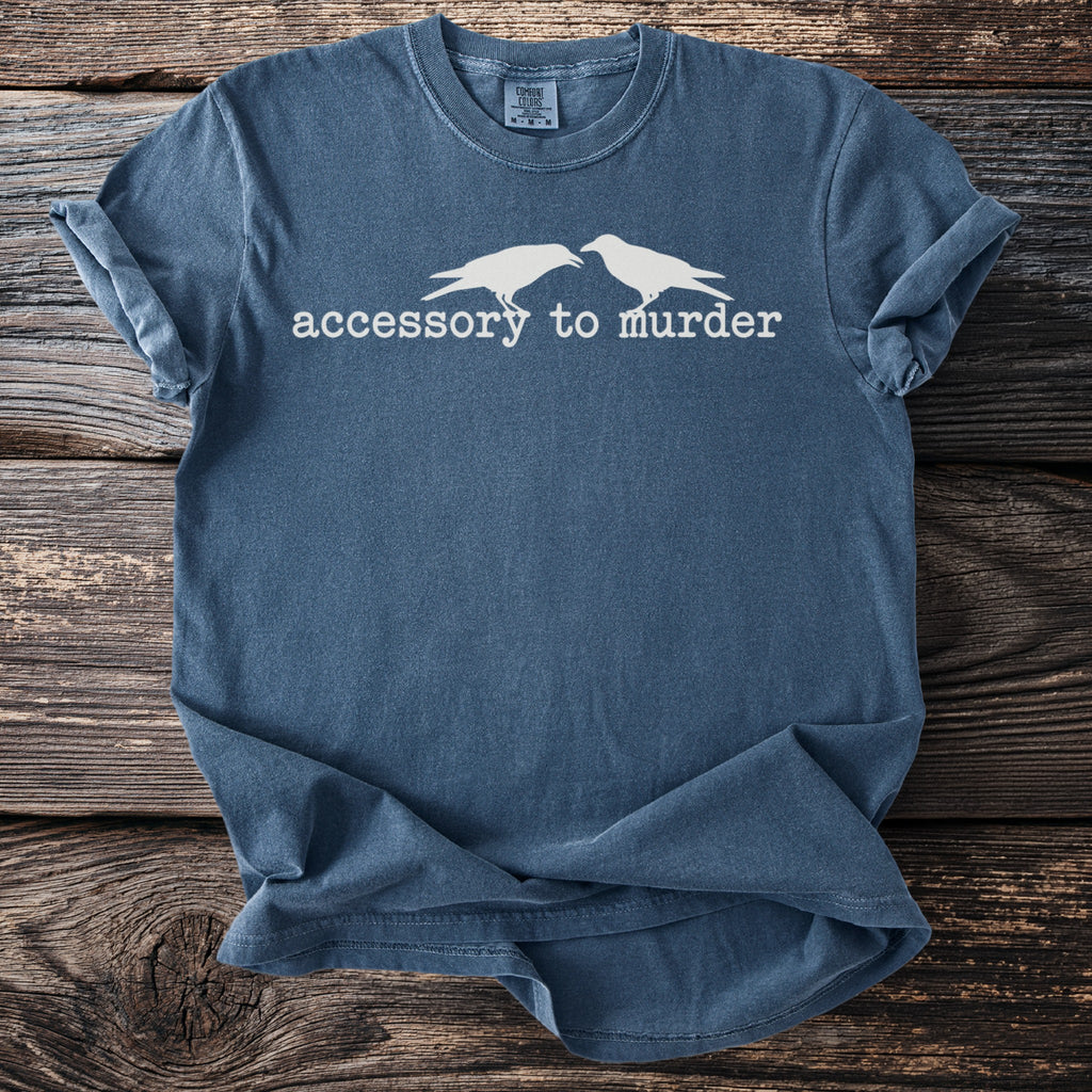 Blue t-shirt with white crows and "accessory to murder" text.