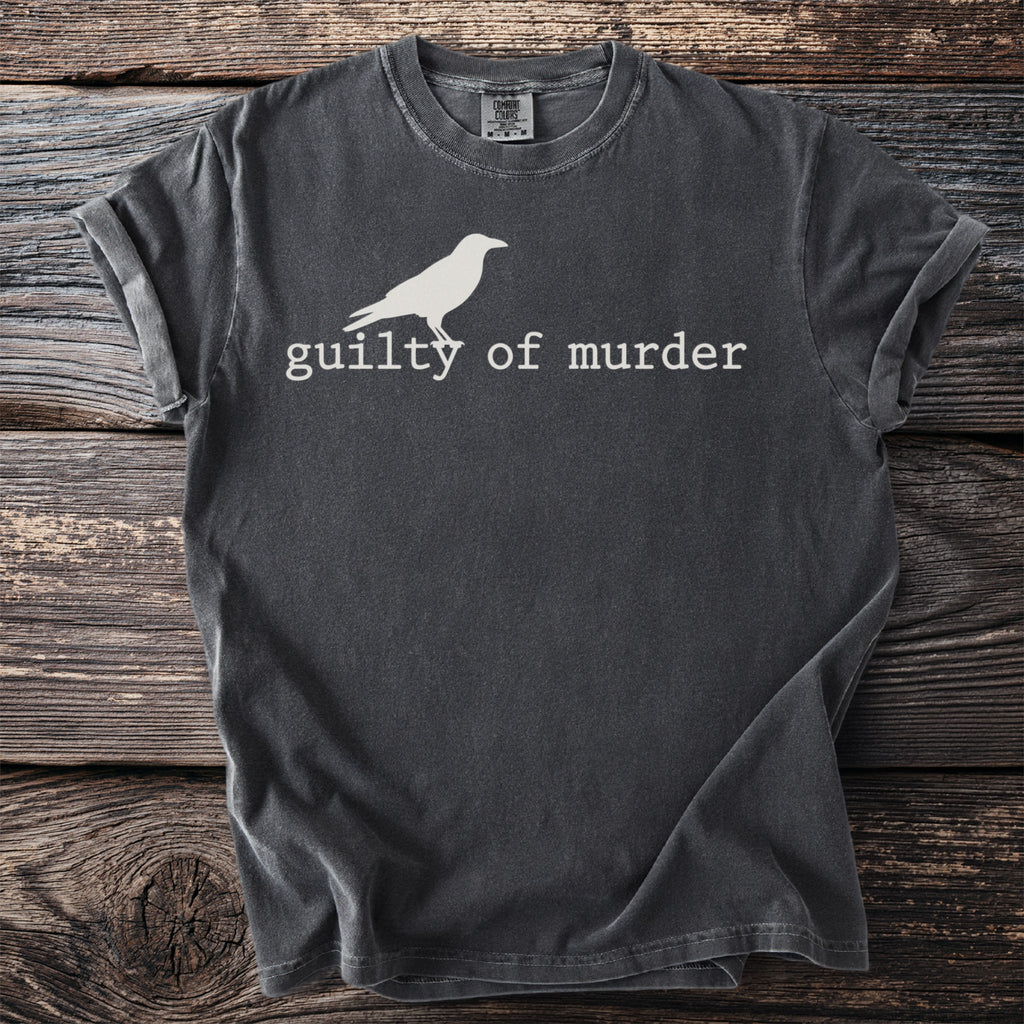 Dark grey t-shirt with a white crow graphic and text "guilty of murder".