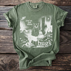 Green t-shirt with a black cat, spider, moth, and text reading "you're not alone there are bugs".