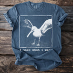 Blue t-shirt with a seagull image and text "i take what i want".
