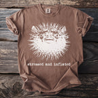 Brown t-shirt with distressed print of a spiky pufferfish and text "stressed and inflated".
