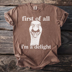 Brown t-shirt with a graphic of a goose and text "first of all i'm a delight".