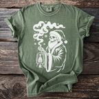 Green t-shirt with a white skeleton Santa holding a lantern surrounded by bats and snowflakes.