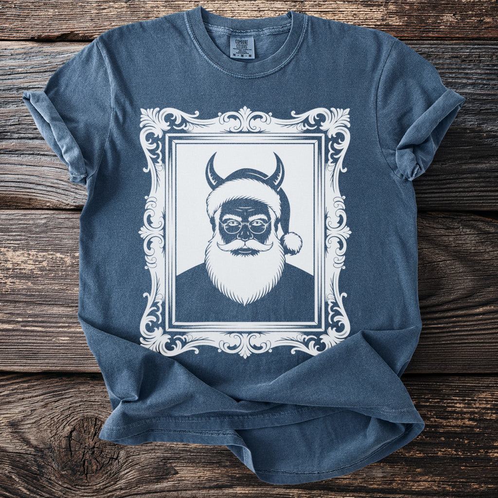Blue t-shirt with white graphic of a horned Santa in a decorative frame.
