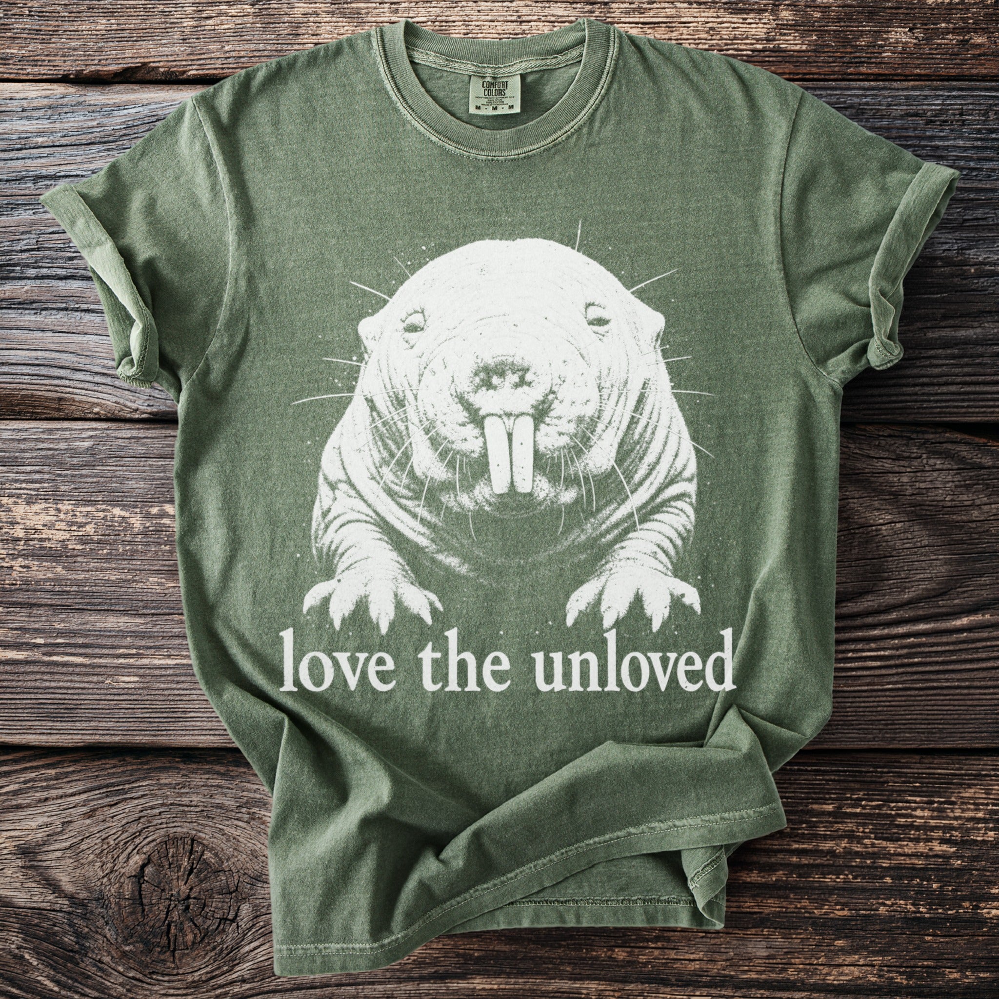 Green t-shirt with white naked mole rat print and "love the unloved" text.