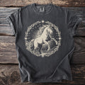 Dark grey t-shirt with a cream linocut-style horse within a celestial wreath design.