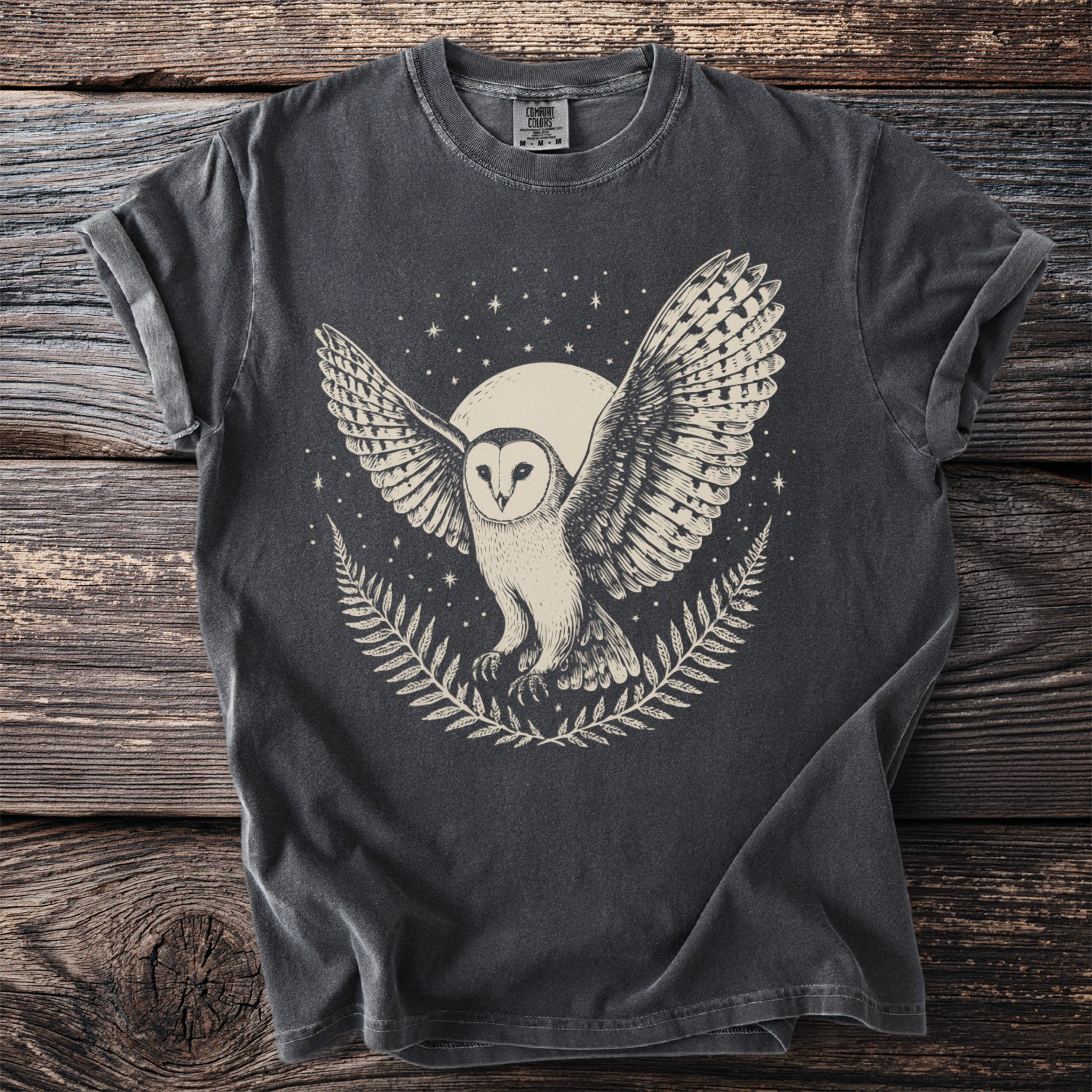 Dark grey t-shirt with a cream-colored graphic of a barn owl with wings spread.