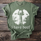 Green t-shirt with white graphic of a turkey and text that reads "i have beef."
