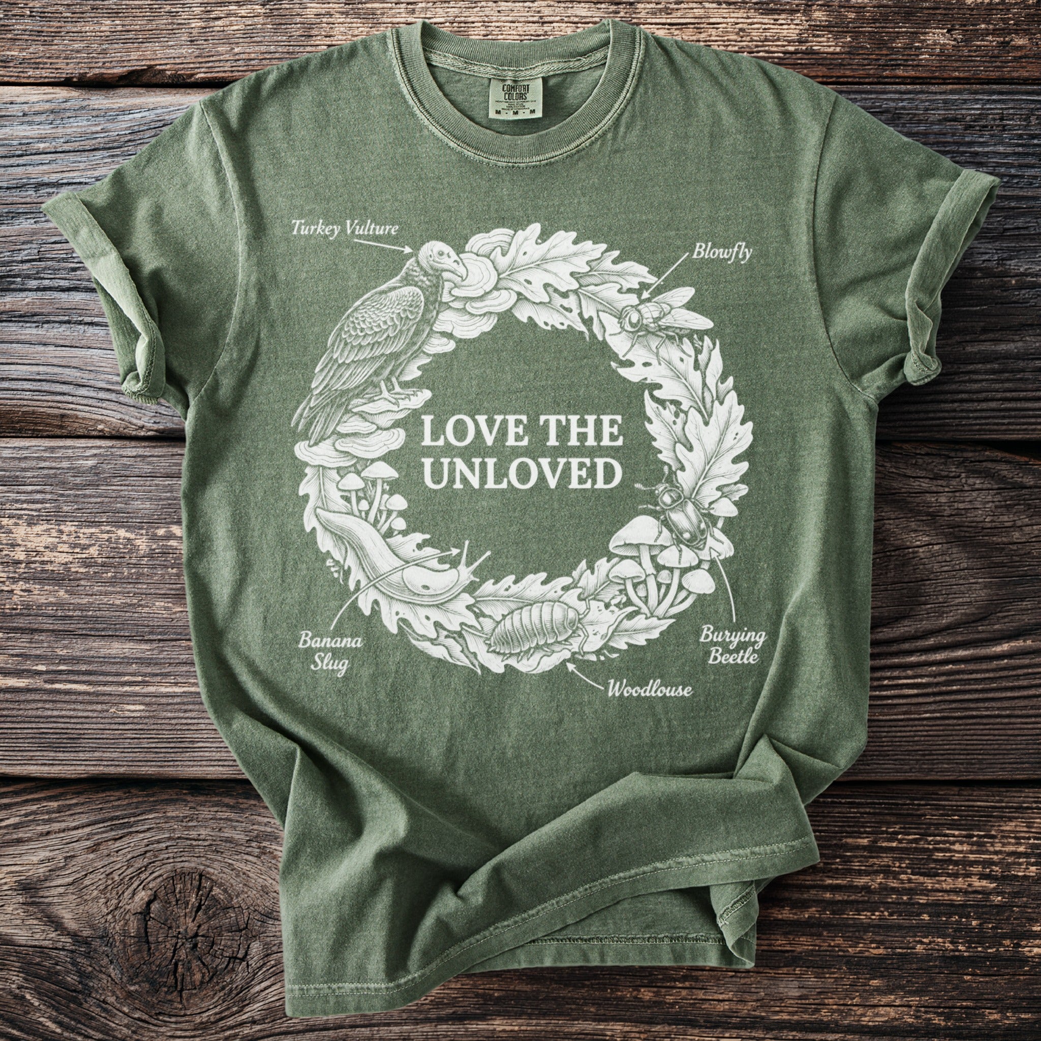 Green T shirt with Love the Unloved and a wreath of forest decomposers.