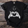 Black t-shirt with white graphic of a hooded figure making a heart shape with hands and a moth.