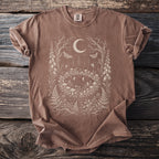 Brown t-shirt with a fairy forest, mushrooms, and moon graphic.