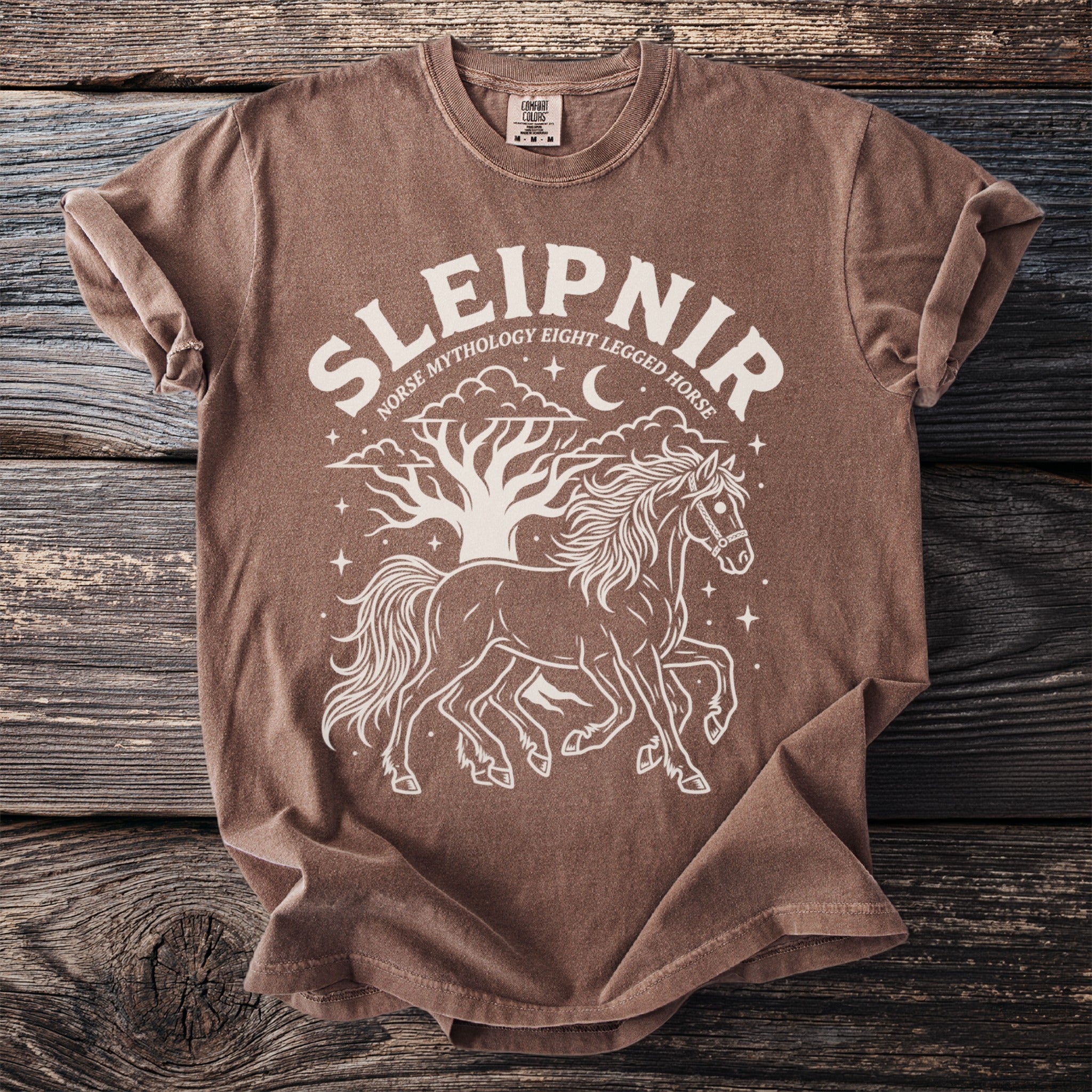Brown t-shirt with white graphic of Sleipnir, Norse eight-legged horse, tree, moon and stars.