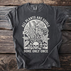 Dark grey t-shirt with white text "ALL PLANTS ARE EDIBLE SOME ONLY ONCE" and floral skull graphic.