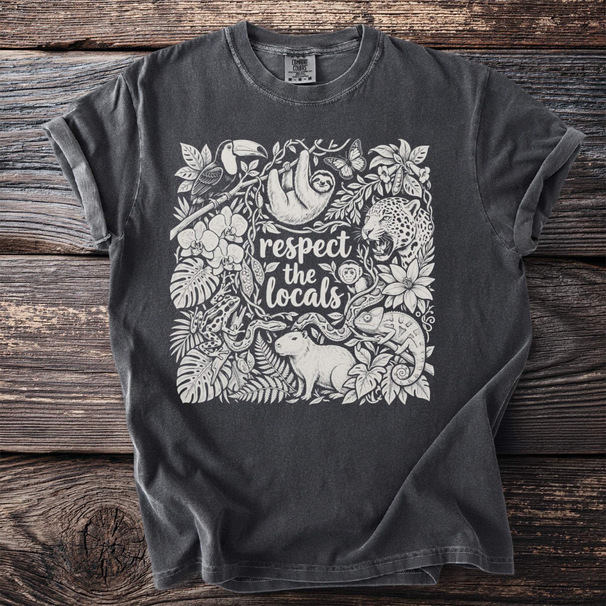 T-shirt with jungle animals and the text "respect the locals" in a floral design.