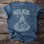 Selkie scottish seal folk legend graphic tee with woman, seal, waves, moon, and stars.