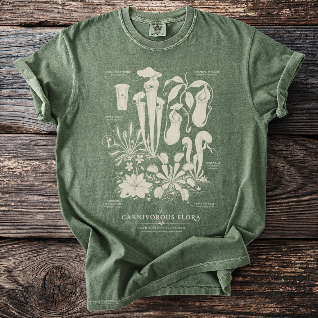 Green t-shirt with botanical illustration of carnivorous plants and text "CARNIVOROUS FLORA".