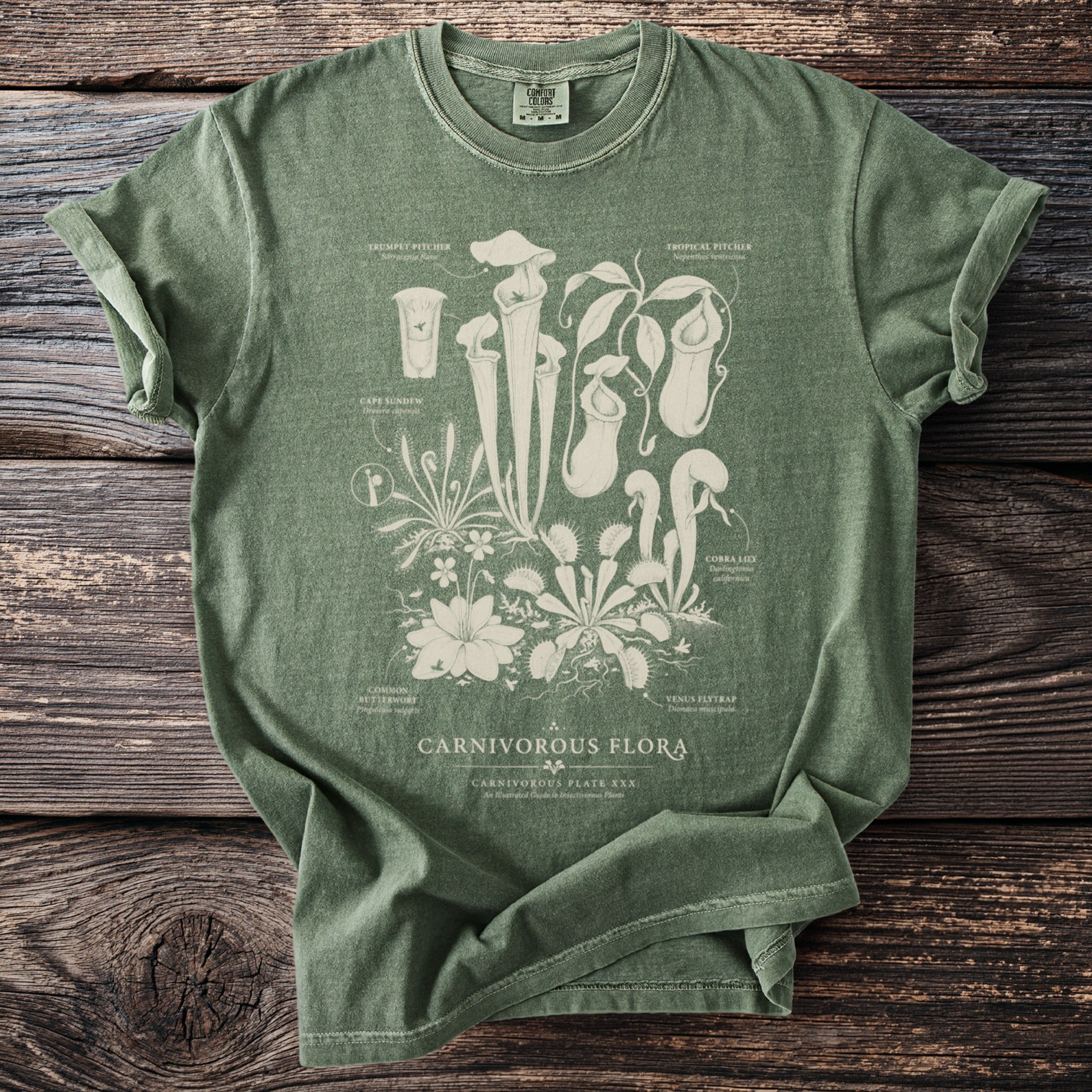 Green t-shirt with botanical illustration of carnivorous plants and text "CARNIVOROUS FLORA".