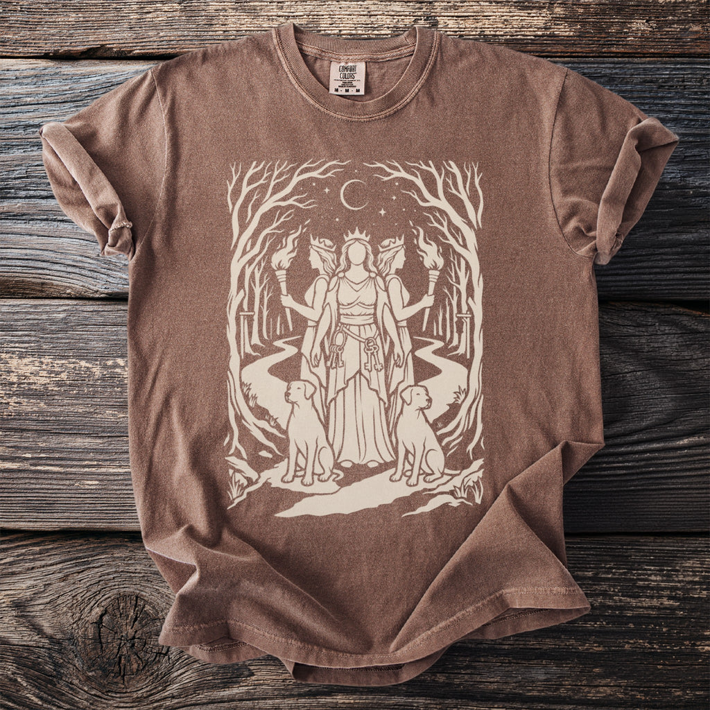 Brown t-shirt with a cream illustration of a goddess with two dogs and torches.