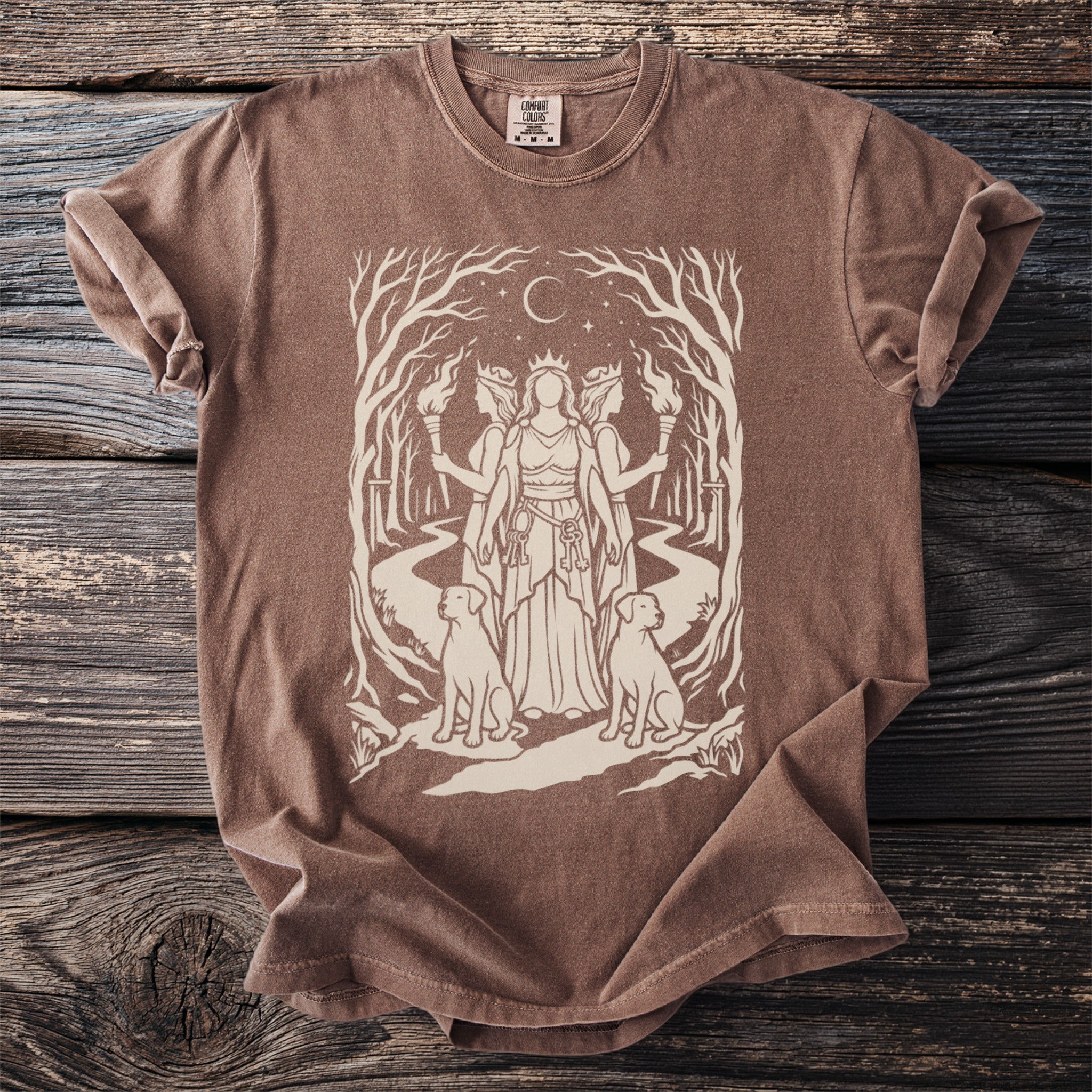 Brown t-shirt with a cream illustration of a goddess with two dogs and torches.