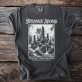 Strange Aeons t-shirt with a dark castle and text "One night only - when the stars are right".