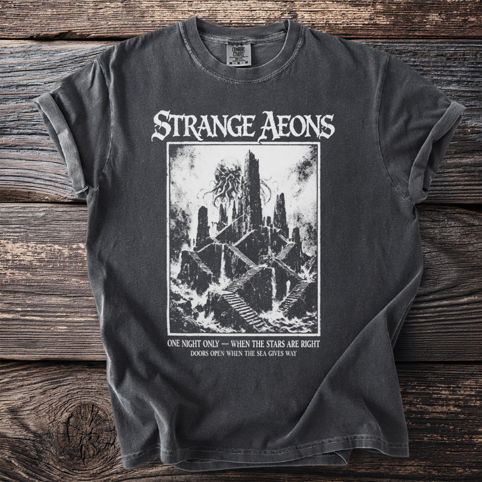 Strange Aeons t-shirt with a dark castle and text "One night only - when the stars are right".