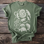 Green t-shirt with charcoal sketch-style print of various reptiles and amphibians.