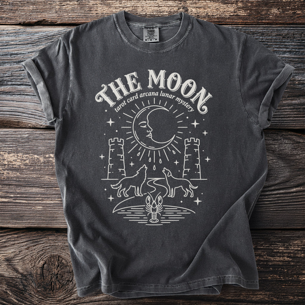 Dark gray t-shirt with "The Moon tarot card arcana lunar mystery" graphic.