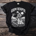 Grim Reaper graphic with scythe and hourglass on black t-shirt.