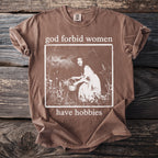 Brown t-shirt with "god forbid women have hobbies" and vintage image.