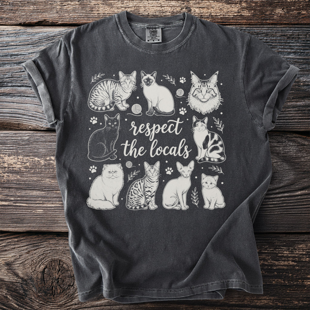 T-shirt featuring line drawings of various cats with the text "respect the locals."