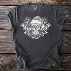 Dark gray t-shirt with white sugar skull, bat wings, Santa hat, and holly design.