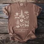 Brown t-shirt with a botanical illustration of "The Wildflower Meadow."