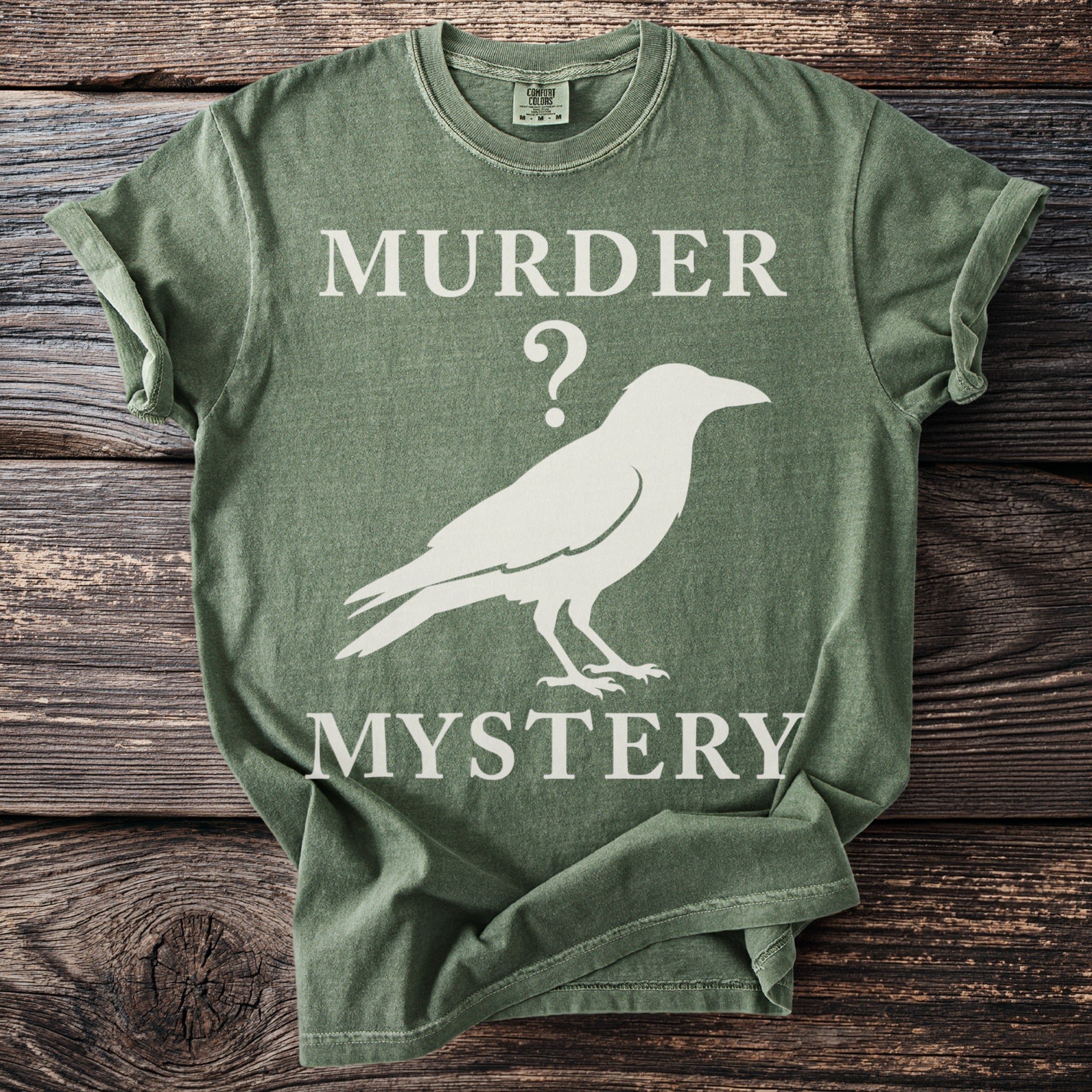 Green t-shirt with "Murder Mystery" and a crow graphic.