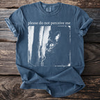 Blue t-shirt with "please do not perceive me" and a peeking cat graphic.