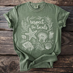 Green t-shirt with white line art of sea creatures and "respect the locals" text.