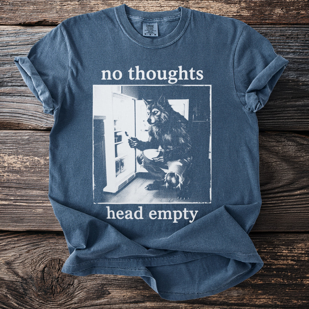 Blue t-shirt with "no thoughts head empty" text and wolf in refrigerator graphic.