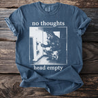 Blue t-shirt with "no thoughts head empty" text and wolf in refrigerator graphic.