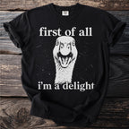 Black t-shirt with white text "first of all" above a goose and "i'm a delight" below.