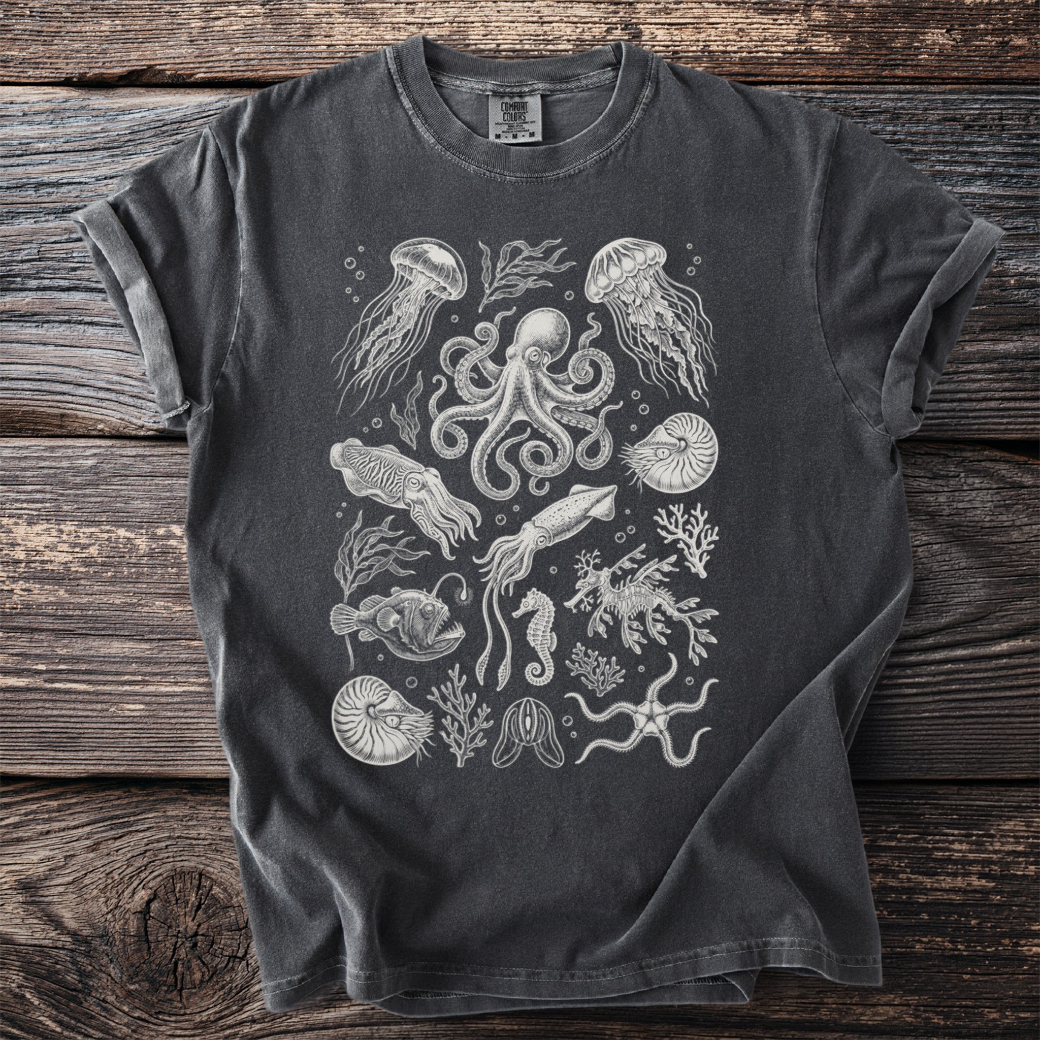 Dark gray t-shirt with an intricate white line art print of various sea creatures and coral.