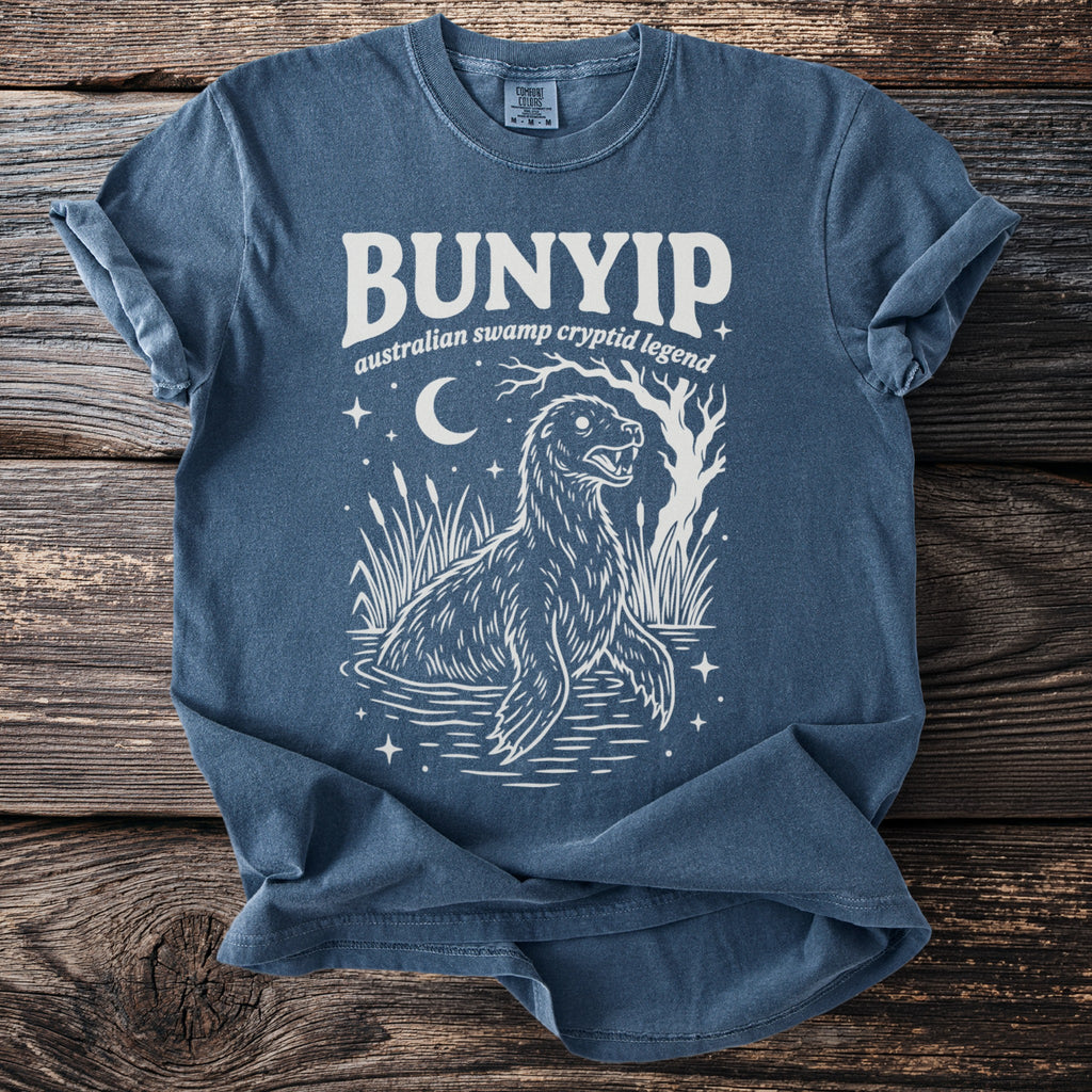 Bunyip Australian swamp cryptid legend graphic on a blue t-shirt.