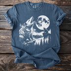 Opossum howling at moon with wolf in stylized forest scene on blue t-shirt.