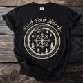 Black t-shirt with cream graphic of a snake coiled around a compass rose and trees.