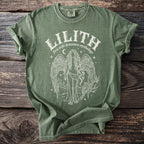 Green t-shirt with white graphic of Lilith, wings, snake, owls, and text.