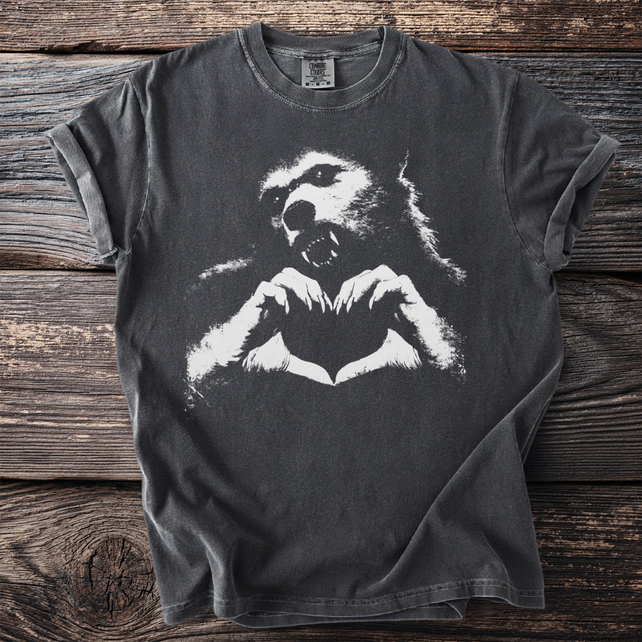 Gray t-shirt with a white graphic of a werewolf forming a heart with its hands.